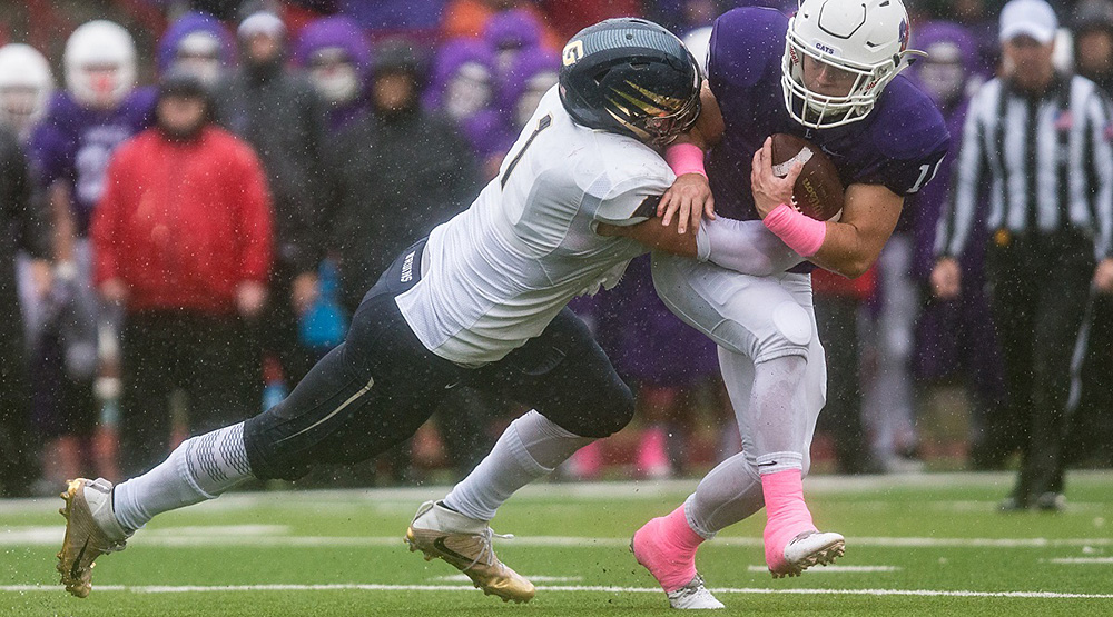 Caleb Dalzell tackles a Linfield ballcarrier