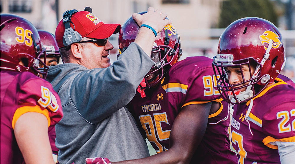 New CUC coach Mike Juscik on the sidelines congratulating players