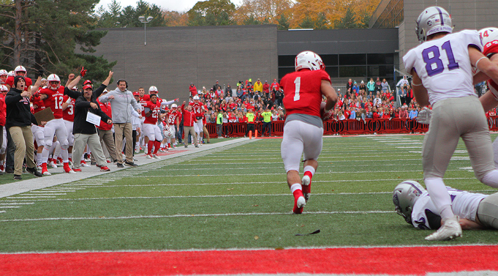 Max Jackson takes off after picking up a fumble, while the St. John's sideline celebrates. He ran 99 yards for the game-clinching touchdown. (Photo by Wade Gardner, d3photography.com)