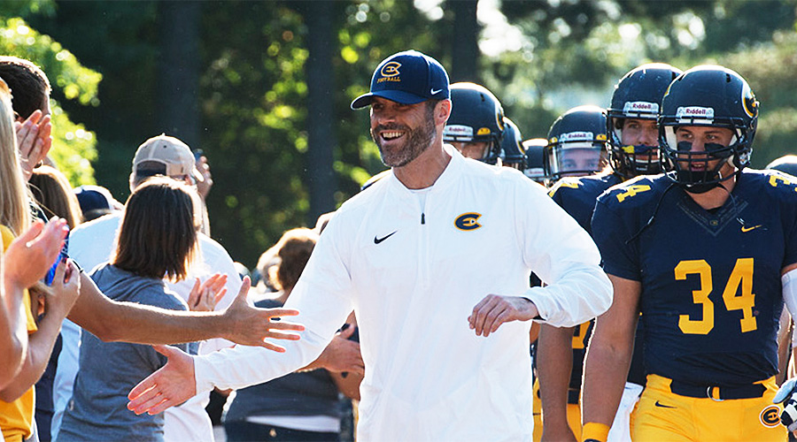 Dan Larson shakes hands with UW-Eau Claire fans on the way into Carson Park. (UW-Eau Claire athletics photo)